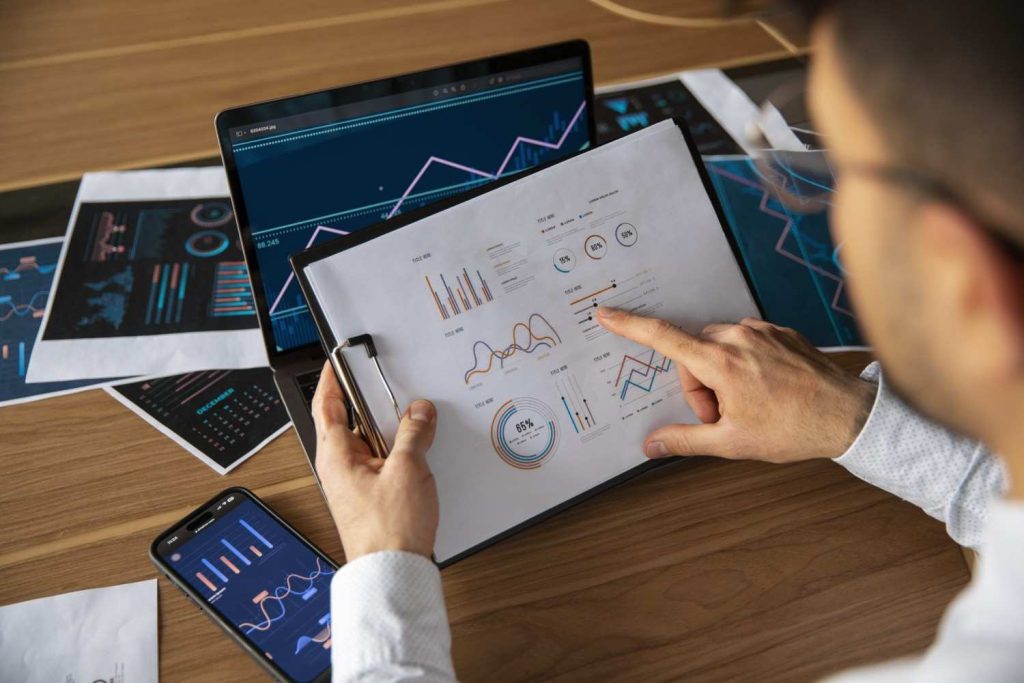 office-workers-using-finance-graphs-scaled